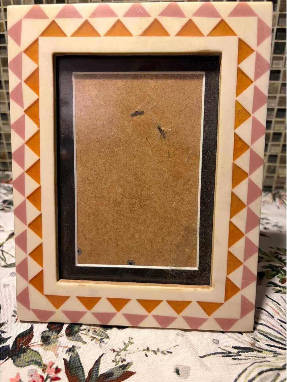 contemporary decorative frame featuring geometric inlaid triangular pattern